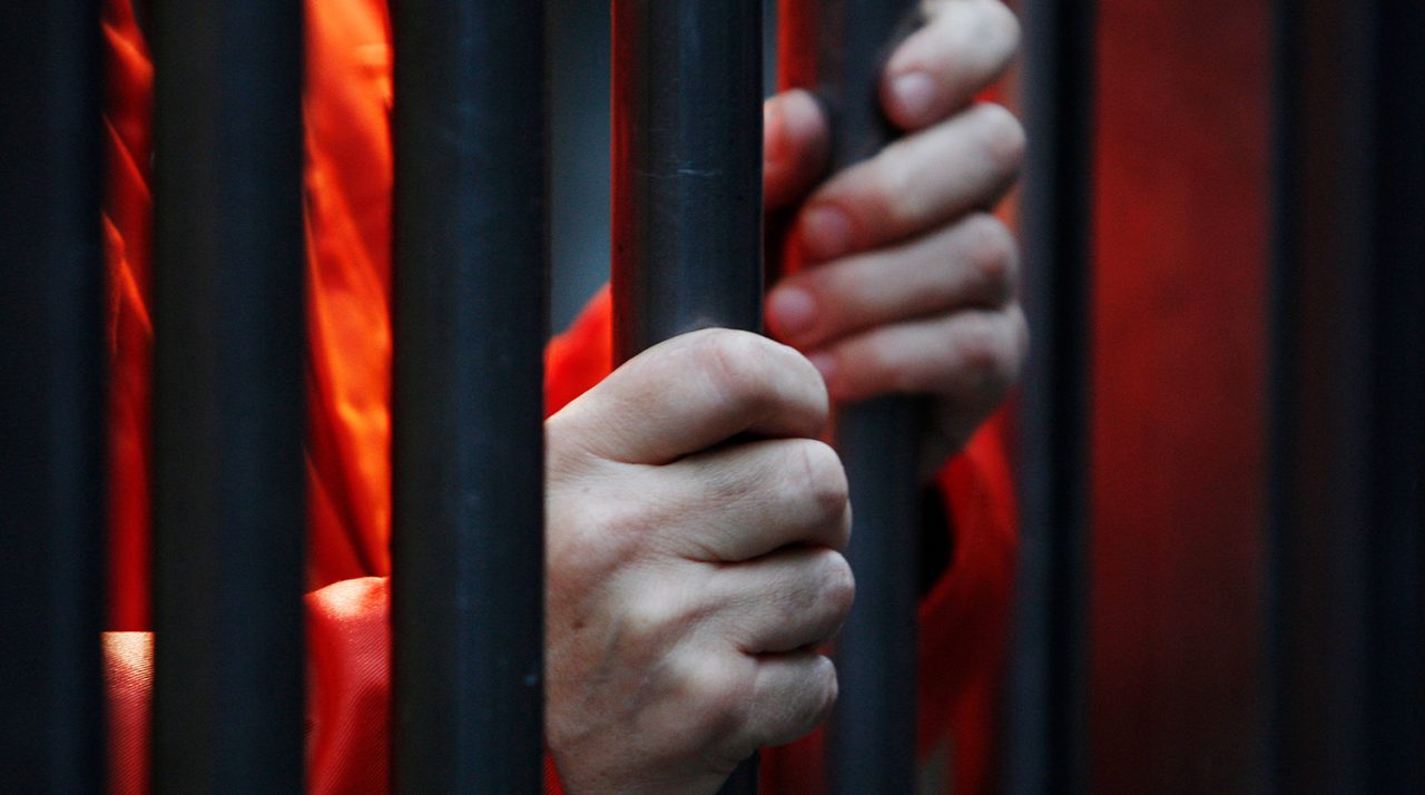 Protestors mark the sixth anniversary of the first transfers of detainees to Guantanamo Bay by standing in cells outside the U.S. Embassy in London